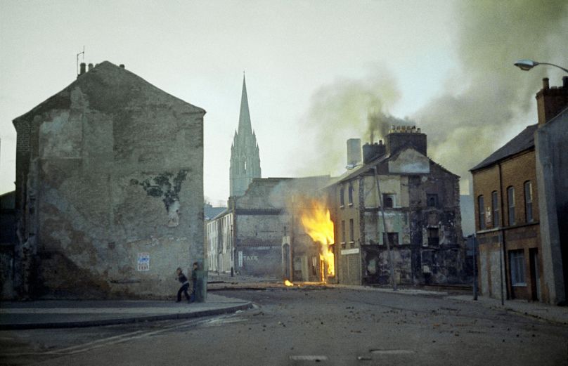 FILE - A building burns in Londonderry/Derry, Northern Ireland, in the aftermath of Bloody Sunday, one of the the most notorious events of the Troubles, in February, 1972.
