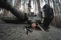 A Ukrainian soldier from 57th brigade looks out from a Swedish Combat Vehicle 90 near front line in Kharkiv region, Ukraine, Tuesday, June 18, 2024. (AP Photo/Andrii Marienko)