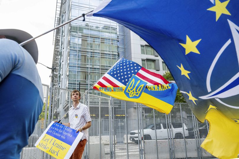 Pro-Ukraine demonstrator Thomas Cooney holds a flag outside the NATO summit in Washington, Wednesday, July 10, 2024. (AP Photo/Noah Berger)
