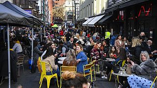People outside cafes and pubs in Soho, central London, UK. April 12, 2021.