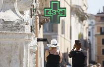 A man takes a photo of the temperature of 43 degrees C (109 degrees F) recorded in the sun outside a pharmacy in downtown Rome, Thursday, July 11, 2024.