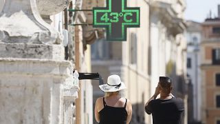 A man takes a photo of the temperature of 43 degrees C (109 degrees F) recorded in the sun outside a pharmacy in downtown Rome, Thursday, July 11, 2024.