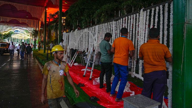 Workers decorate the venue ahead of billionaire Mukesh Ambani's son Anant Ambani's wedding to Radhika Merchant at Jio World Convention Centre