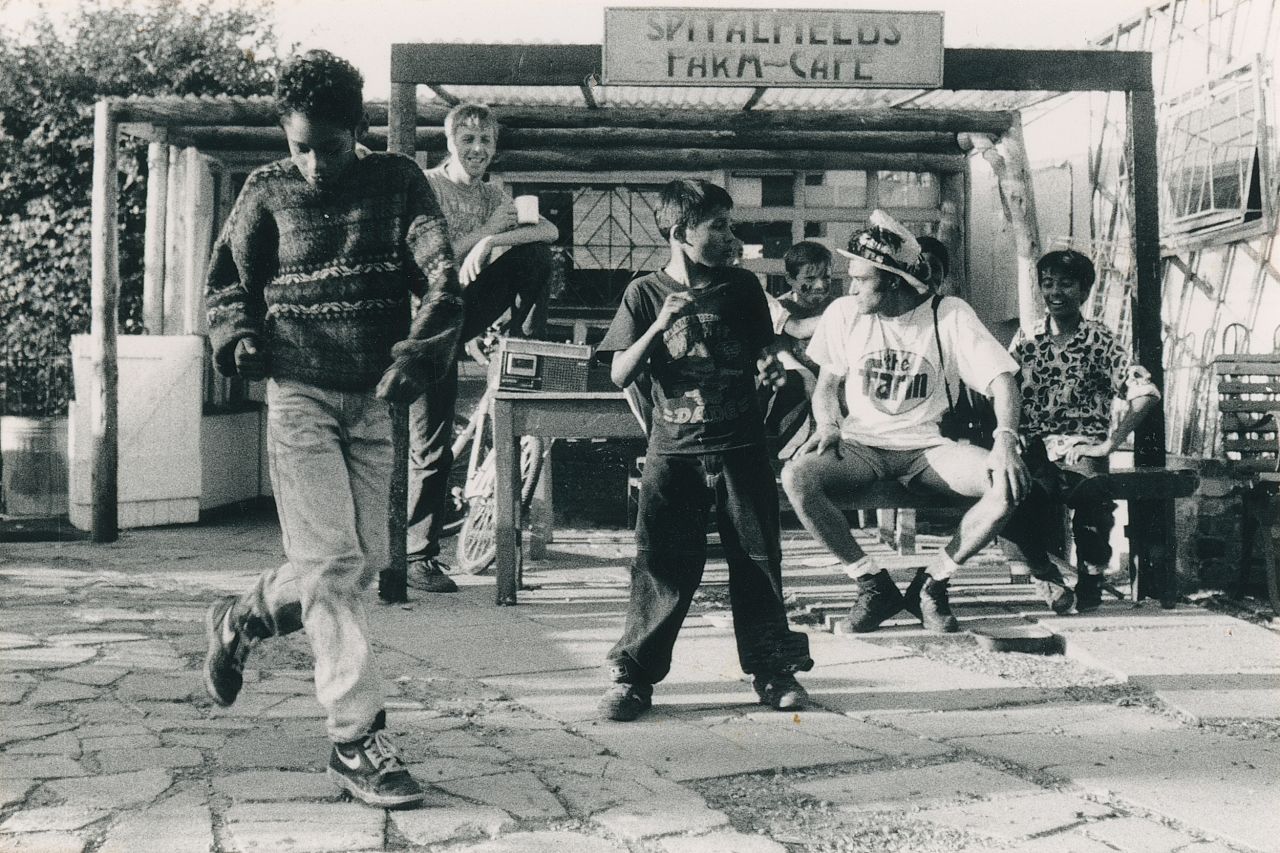 Daniele Lamarche, Two boys dancing to music on the radio at Spitalfields Farm, Tower Hamlets, 1990s