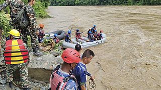 At least 60 missing in Nepal after two buses swept into a river