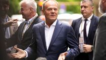 FILE - Poland's Prime Minister Donald Tusk speaks with the media as he arrives for a meeting of the EPP party ahead of an EU summit in Brussels, Monday, June 17, 2024.