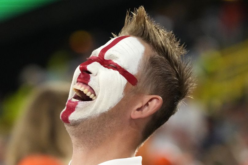 A fan smiles before the semifinal match between the Netherlands and England at the Euro 2024 soccer tournament in Dortmund, Germany