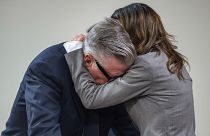 Actor Alec Baldwin, right, hugs his wife after the judge threw out the involuntary manslaughter case, July 12, 2024