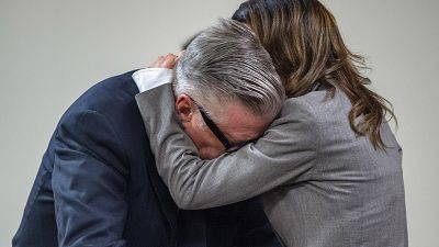Actor Alec Baldwin, right, hugs his wife after the judge threw out the involuntary manslaughter case, July 12, 2024