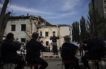 The conductor German Makarenko leads the orchestra, which is playing on the site of the Russian missile attack on the children's hospital, in Kyiv, Ukraine, July 12, 2024