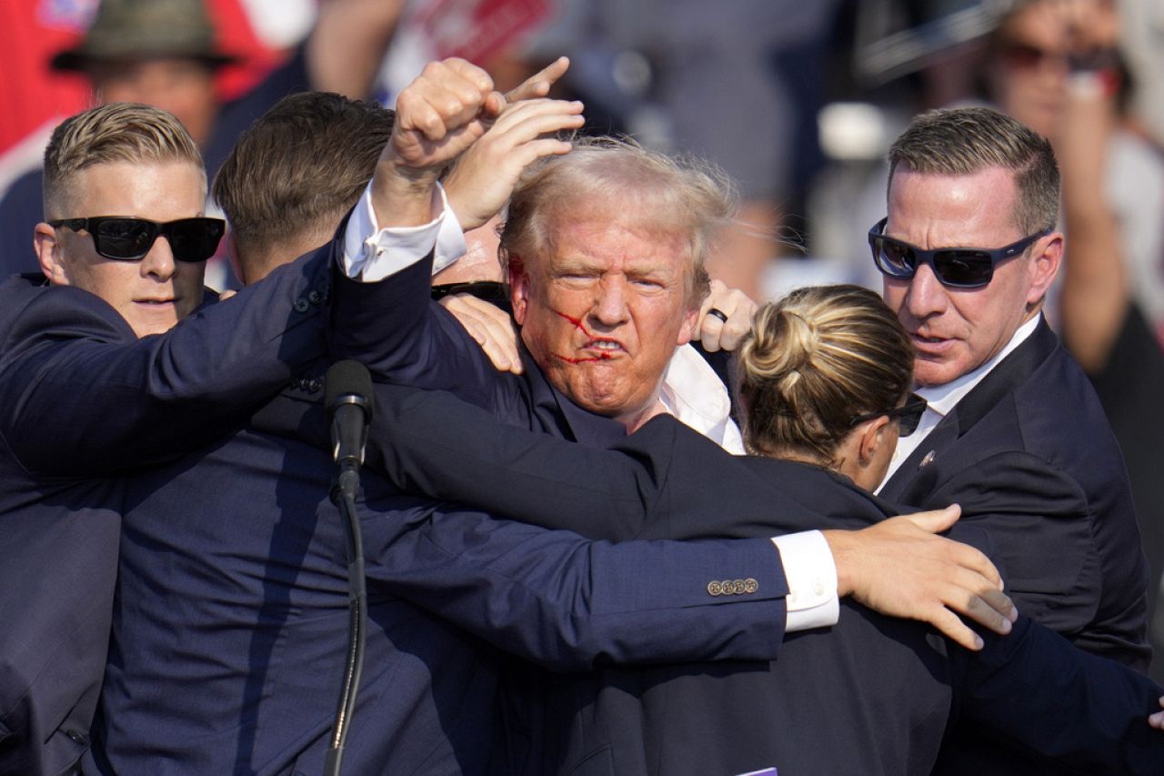 There appeared to be blood on Trump's right ear as he was being taken off stage, and he could be seen mouthing "fight" and pumping his fist.