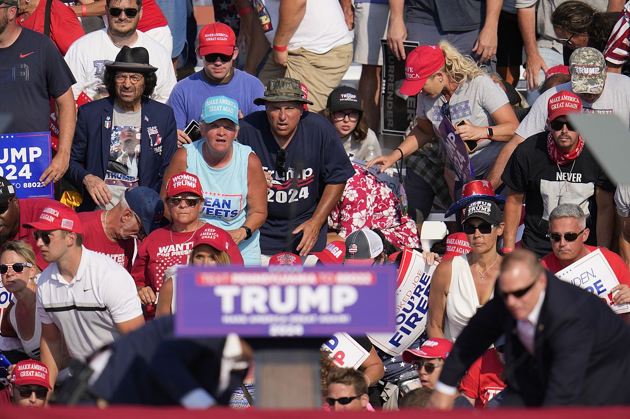 The crowd reacts as Republican presidential candidate former President Donald Trump is surrounded by U.S. Secret Service agents at a campaign event in Butler