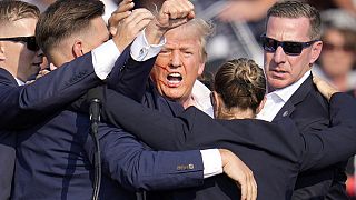 Republican presidential candidate former President Donald Trump is helped off the stage by U.S. Secret Service agents at a campaign event in Butler