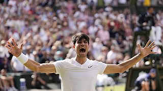 Carlos Alcaraz of Spain celebrates after defeating Novak Djokovic of Serbia during the men's singles final at the Wimbledon tennis championships in London, Sunday, July 14.