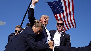 Republican presidential candidate former President Donald Trump is surrounded by U.S. Secret Service agents at a campaign rally, Saturday, July 13, 2024, in Butler, Pennsylva.