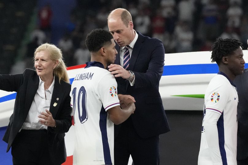 UK's Prince William tries to console England's Jude Bellingham as he hands him the Euro 2024 silver medal