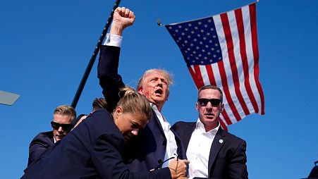 Republican presidential candidate former President Donald Trump gestures after surviving an assassination attempt on stage at a campaign rally in in Butler, Pa. 