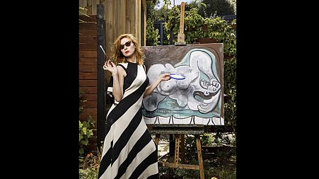 Kirsha Kaechele poses with a painting.