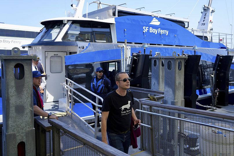 A person walks off the MV Sea Change, the first commercial passenger ferry powered by hydrogen fuel cells.