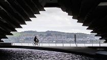 A cyclist rides along the River Tay in Dundee, Scotland.