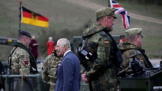 Britain's King Charles III talks with soldiers during his visit at the 130th German-British Pioneer Bridge Battalion military unit in Finowfurt