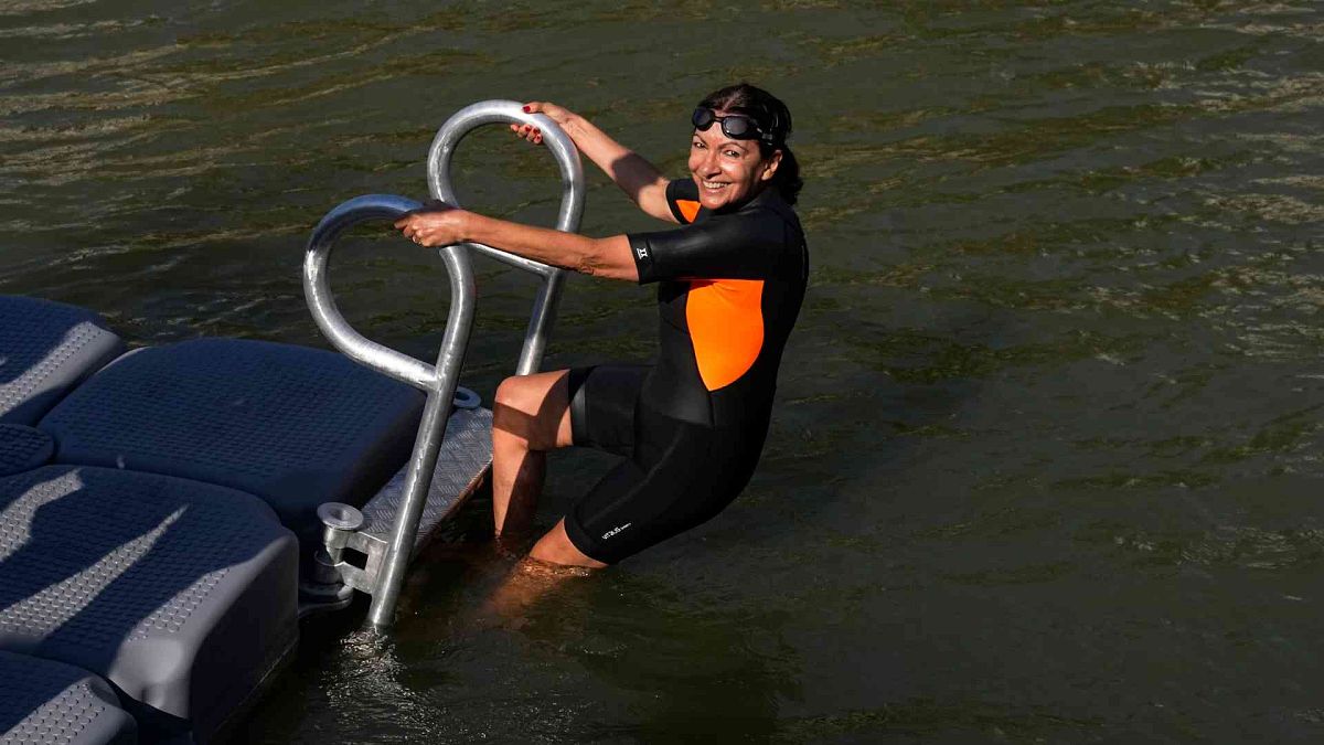 Paris Mayor Anne Hidalgo enters the Seine river Wednesday, July 17, 2024 in Paris. 