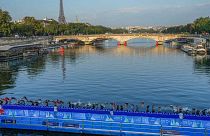 Atlete si tuffano nella Senna dal ponte Alessandro III per la prima tappa della prova di triathlon femminile per le Olimpiadi di Parigi 2024 a Parigi, 17 agosto 2023.