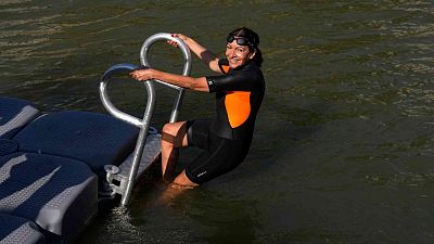 Paris Mayor Anne Hidalgo enters the Seine river Wednesday, July 17, 2024 in Paris. 