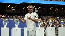 Kylian Mbappe, of France, poses for the cameras after being presented to fans as a new Real Madrid player at the Santiago Bernabeu stadium in Madrid, Tuesday, July 16, 2024.