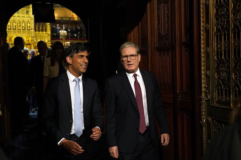 Prime Minister Keir Starmer and former Prime Minister Rishi Sunak walk from the House of Lords after listening to the King's Speech.