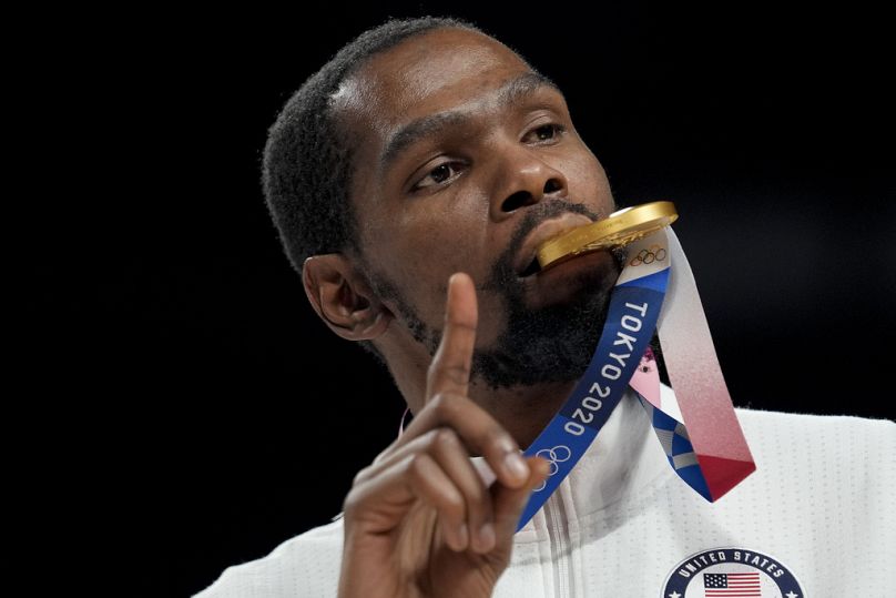 Kevin Durant poses for a photo with his gold medal during the medal ceremony for basketball game at the 2020 Summer Olympics, Saturday, Aug. 7, 2021