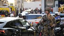 A soldier stands guard near the Champs-Elysees avenue after a stabbing in Paris, July 18, 2024