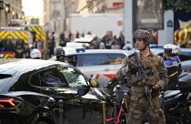A soldier stands guard near the Champs-Elysees avenue after a stabbing in Paris, July 18, 2024