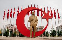 A statue of Atatürk and the Turkish flag