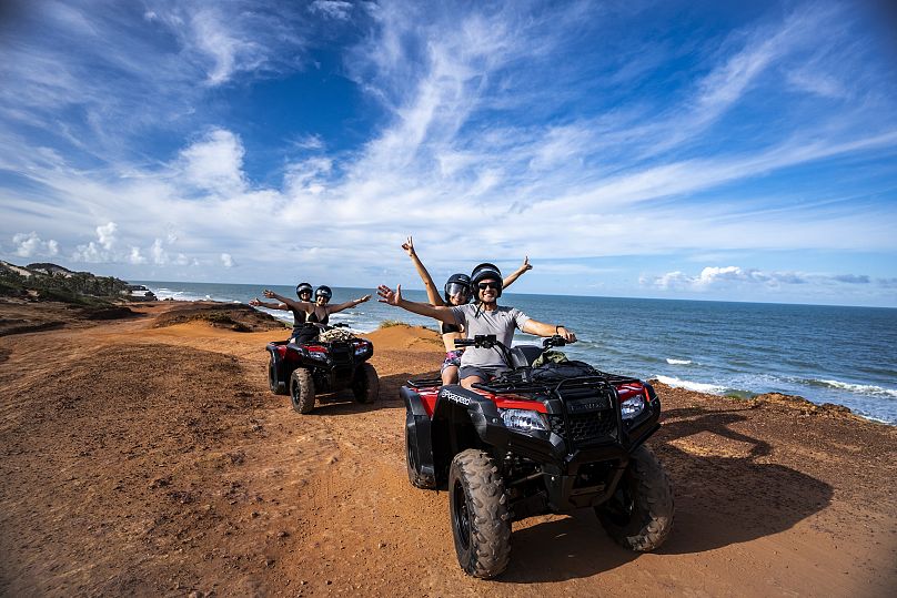 A group of friends on four-wheelers in Pipa