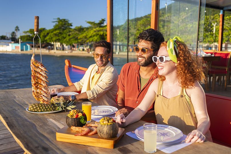 Friends enjoying seafood in Florianópolis