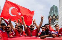 Türk taraftarlar, Euro 2024 çeyrek finalinin başlamasından önce taraftar yürüyüşü sırasında, kökeni aşırı sağcı bir harekete atfedilen 'kurt selamı' veriyor 