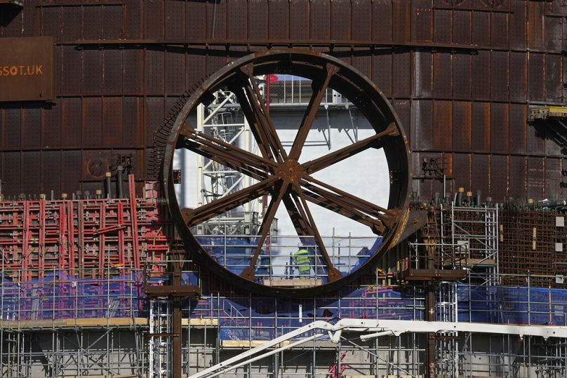 An employee works at the site of a nuclear reactor at Hinkley Point C nuclear power station in Somerset, October 2022