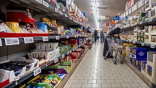 A woman shops in a discount market in Frankfurt, Germany