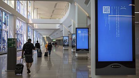Screens show a blue error message at a departure floor of LaGuardia Airport in New York on Friday, July 19, 2024, after the Crowdstrike outage.