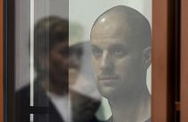 Wall Street Journal reporter Evan Gershkovich stands listening to the verdict in a glass cage in a courtroom in Yekaterinburg, 19 July 2024, FILE