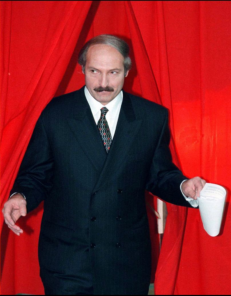 President Alexander Lukashenko of Belarus emerges from a polling booth after voting in a national referendum