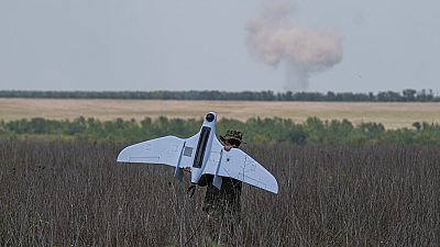 A Ukrainian serviceman of the Ochi reconnaissance unit carries a Furia drone after Russian airstrikes at the frontline in Donetsk region, Ukraine, June 30 2024