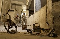 Peacekeepers stand behind two kids’ bicycles inside of an abandoned building inside the UN controlled buffer zone in the central of the divided capital Nicosia, 6 June 2024
