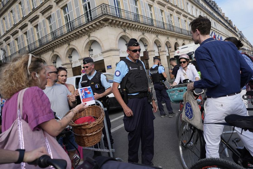 Police officers check authorizations at a check point Thursday, July 18, 2024 in Paris. 