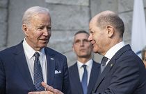 U.S. President Joe Biden, front left, and German Chancellor Olaf Scholz, front right, talk during an extraordinary NATO summit at NATO headquarters in Brussels,  24 March 2022