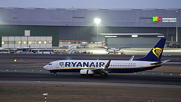 A Ryanair Boeing 737 lands at Lisbon airport, as night falls Friday, Aug. 26, 2022. (AP Photo/Armando Franca)