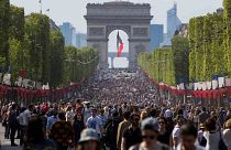 People walk on the Champs Elysees in Paris, France, Sunday, May 8, 2016. 