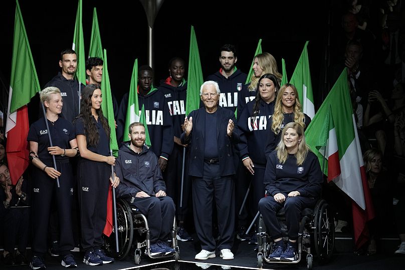 Designer Giorgio Armani accepts applause with Italy's Paralympic team at the end of the Emporio Armani men's Spring Summer 2024 collection presented in Milan, June, 2023. 