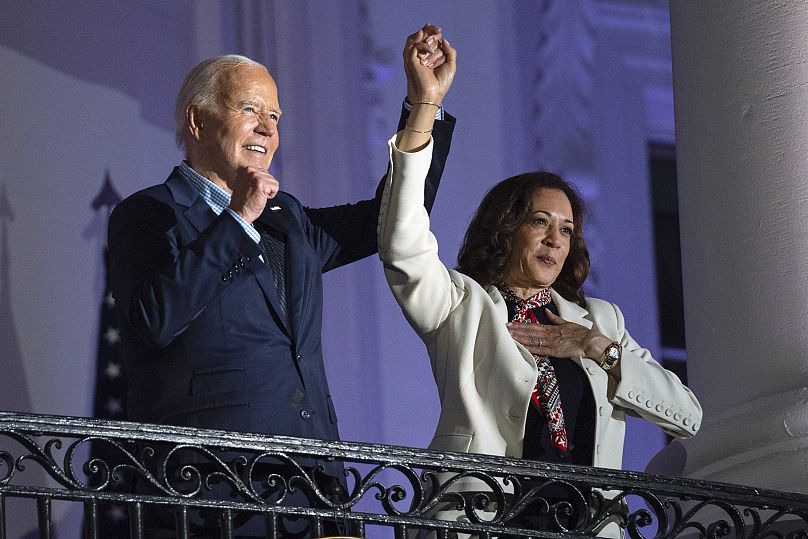 President Joe Biden raises the hand of Vice President Kamala Harris after viewing the Independence Day fireworks in Washington, 4 July 2024. 